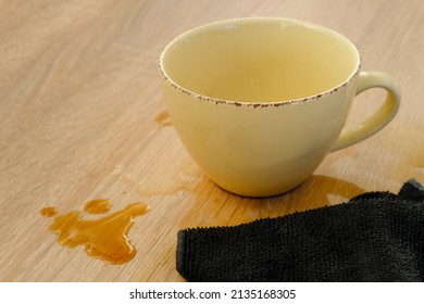 Closeup Of Cup Of Coffee, Tea Suddenly Spills, Hot Liquid Spilled On The Table, Floor, Concept Of Bad Luck, A Hard Day, Careless Handling Of Dishes, An Accident At Workplace