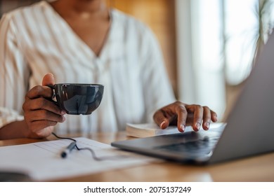 Closeup of a cup of tea, being held by a hardworking businesswoman - Powered by Shutterstock