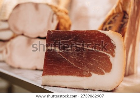Closeup of Cured Ham Slice on Deli Counter, Prosciutto Style Charcuterie and Gourmet Meat