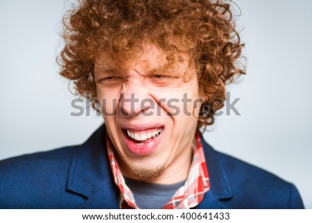 closeup curly man squeamish, isolated on background