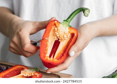 Close-up, cut bell pepper in female hands in the kitchen. - Powered by Shutterstock