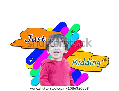 Closeup cute asian kid in cheeky motion with just kidding word in text box isolated on white background