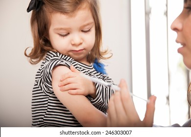 Closeup Of A Cute Little Girl Getting A Flu Shot At A Doctor's Office