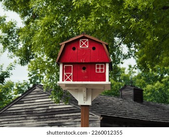A closeup of a cute red barn birdhouse at Deanna Rose Farmstead in Overland park Kansas