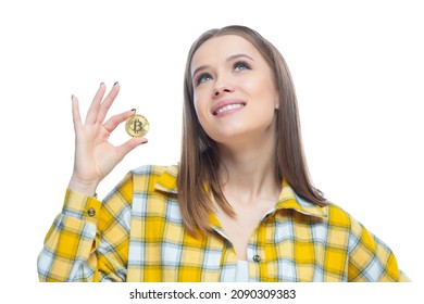 Closeup Of Cute Smiling Girl Holding A Physical Bitcoin Cryptocurrency In Her Hand Isolated On White Background. Concept Of Financial Literacy, Innovation, Success