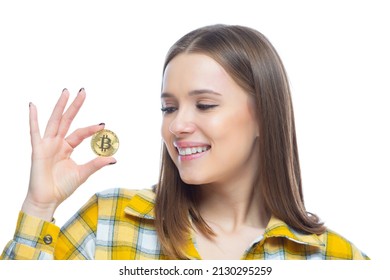 Closeup Of Cute Smiling Girl Holding A Physical Bitcoin Cryptocurrency In Her Hand Isolated On White Background. Concept Of Financial Literacy, Innovation, Success