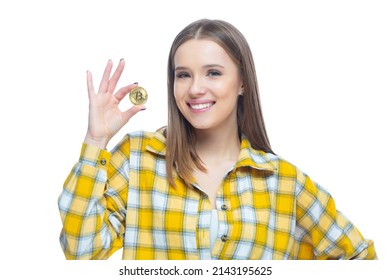 Closeup Of Cute Smiling Girl Holding A Physical Bitcoin Cryptocurrency In Her Hand Isolated On White Background. Concept Of Financial Literacy, Innovation, Success