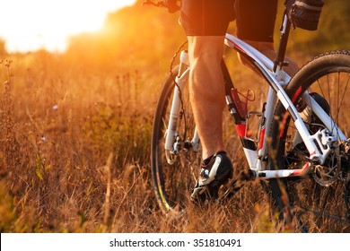 Closeup of cyclist man legs riding mountain bike on outdoor trail in autumn forest - Shutterstock ID 351810491