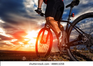 Closeup of cyclist man legs riding mountain bike on outdoor trail in autumn forest - Shutterstock ID 488811058