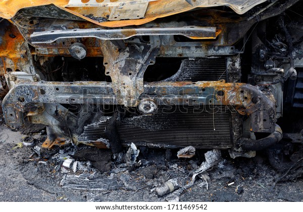 A close-up of a damaged car radiator after a\
fire to illustrate an article about a fire, an insured event,\
damage compensation
