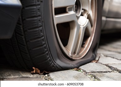 Close-up Of A Damaged Flat Tire Of A Car On The Road