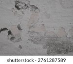Close-up of a damaged wall surface with peeling paint and visible cracks. The textured background shows signs of aging, moisture damage, and wear, making it ideal for concepts related to renovation, decay, and urban textures.
