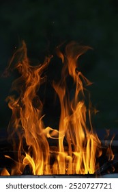 Close-up of Dancing Flames with Dark Background: Dynamic Fire and Heat Concepts