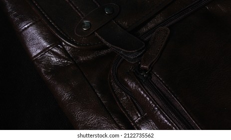 A Closeup Of The Dark Brown Leather Bag Detail On Dark Background 