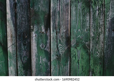 Closeup dark green rough wood old fence. Beautiful green not flat background. 