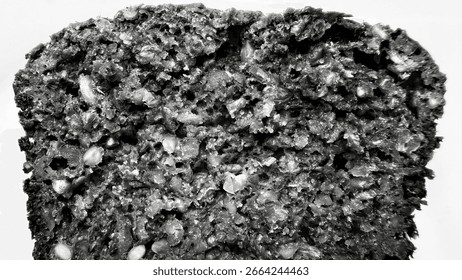 closeup of dark multigrain bread slice showing dense moist crumb texture with visible seeds for bakery menu or artisan food design


