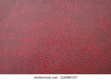 Close-up of dark red imitation leather, leatherette as texture or background