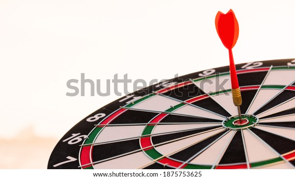 Closeup the dart\
arrow hit center on Bullseye(bull\'s-eye) of a dartboard is a target\
of challenge business, strategy marketing target, objective\
financial and goal a\
concept