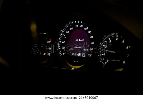 Close-up of\
dashboard lights of a car at\
night