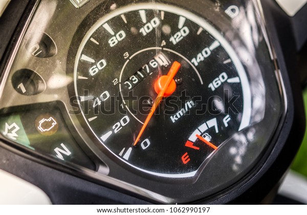 Closeup dashboard of\
mileage motorcycle