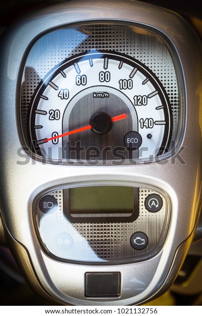 Closeup\
dashboard and speedometer of a\
motorcycle