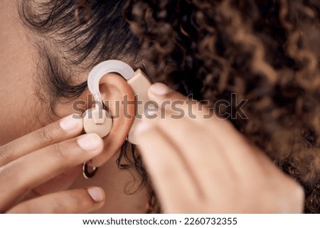 Closeup, deaf and woman with cochlear implant for hearing, audio and aid for disability or impairment. Sound, hands and girl fitting device to help with communication, listening and interaction