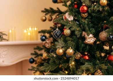 A close-up of a decorated Christmas tree with vintage glass toys. Stylish rich interior with fireplace and lighted candles. New year decorations. Copy space. - Powered by Shutterstock