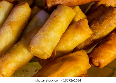 Closeup Of Deep Fried Jalapeno Cheese Sticks Made With Spring Roll Wrapper On A Glass Plate.