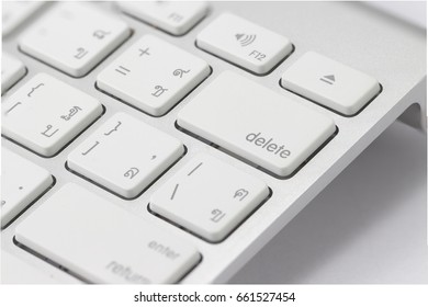 Closeup of delete button on the computer keyboard on the white background.