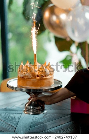 close-up of delicious appetizing cake with lit candle during birthday celebration restaurant