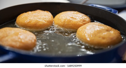 Closeup Of Delicious Home Made Vegan Doughnuts Frying In Oil.