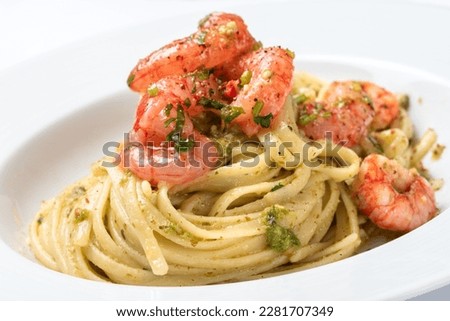 Closeup of delicious linguine with pesto and shrimps, italian cuisine 