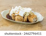 Close-up of delicious stinky tofu. it is a street snack commonly found at night markets or roadside stalls in Taiwan, popular with tourists. 