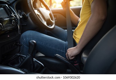 Closeup Of Delivery Man Fastening Seat Belt In Car