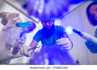 Closeup Dental Examination With Ultraviolet Light In The Office Of The Dentist