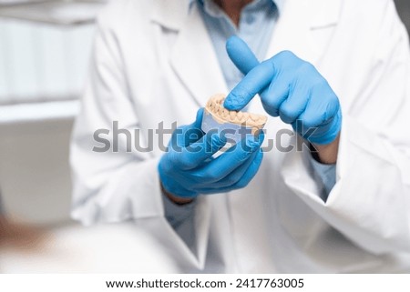 Close-up of a dental impression in the hands of the doctor.