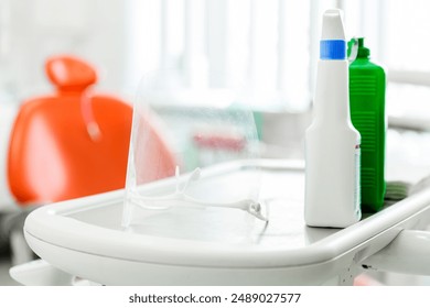 Close-up of dental tools and protective gear on a tray in a dental clinic. Horizontal photo. - Powered by Shutterstock