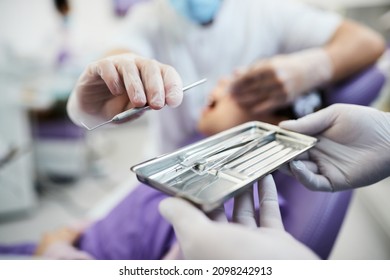 Close-up Of Dentist Working With Dental Scraper Tool During Teeth Check Up At Dental Clinic. 