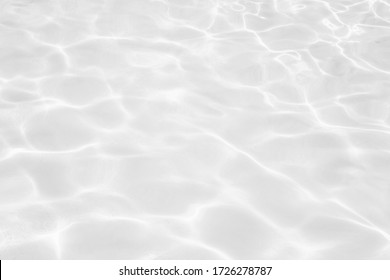 Closeup desaturated transparent clear calm water surface texture and splashes   bubbles  Trendy abstract nature background  