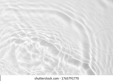 Closeup desaturated transparent clear calm water surface texture and splashes   bubbles  Trendy abstract nature background  