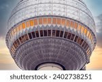 Close-up - Detail of the Berlin TV Tower at Alexanderplatz in Berlin Mitte with dramatic sunset sky