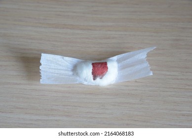 Close-up Detail Of A Cotton Ball And Tape Dressing From With Blood Stains, Previously Used For Phlebotomy. Blood Drawing Or Donating, Medical Service, Health Check Up, Hemostasis Concept.