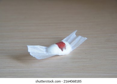 Close-up Detail Of A Cotton Ball And Tape Dressing From With Blood Stains, Previously Used For Phlebotomy. Blood Drawing Or Donating, Medical Service, Health Check Up, Hemostasis Concept.