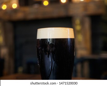 Close-up Detail Of A Glass Of Cold Stout Lager In A Traditional British Pub. Windsor, United Kingdom. Drinks And Cuisine.