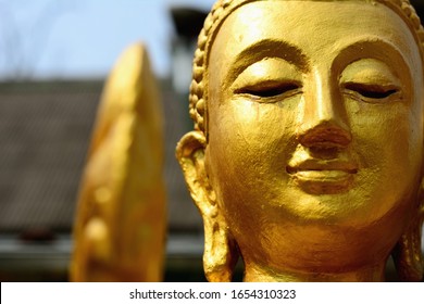 Closeup detail of golden buddha statue, selective focus