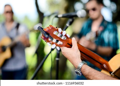 closeup detail hand playing folk guitar outdoor summer festival - Shutterstock ID 1116936032