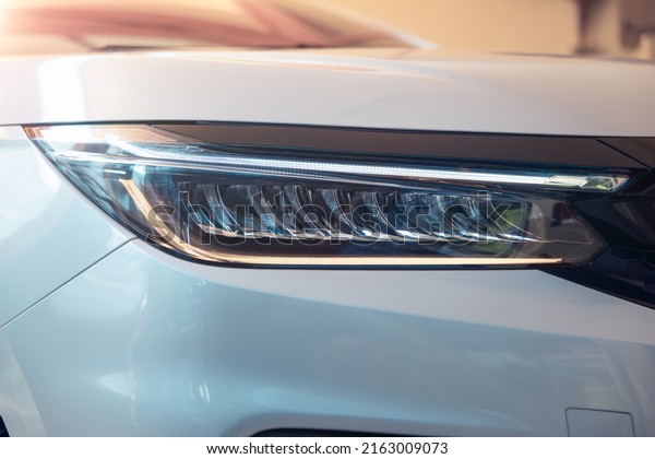 Closeup detail of headlight of auto car consist of\
led bulb, signal indicator turn light, lamp part, daytime running\
light. Concept for automotive vehicle, automobile, luxury, polish,\
clean and wash.