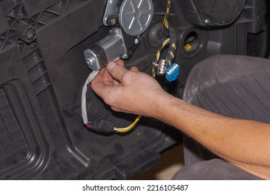 Close-up Detail Of The Mechanic's Hand, Connecting The Window Regulator Cables And The Left Door Speaker Cables, Which He Has Just Repaired In His Workshop In Granada.