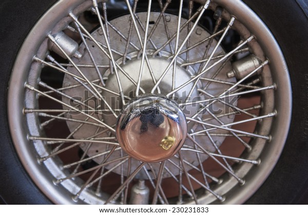 Closeup\
detail of an old car tyre wheel with\
spokes