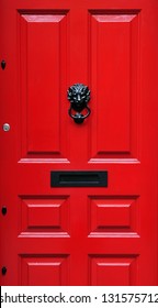 Close-Up Detail Of A Red Front Door Of A London Town House